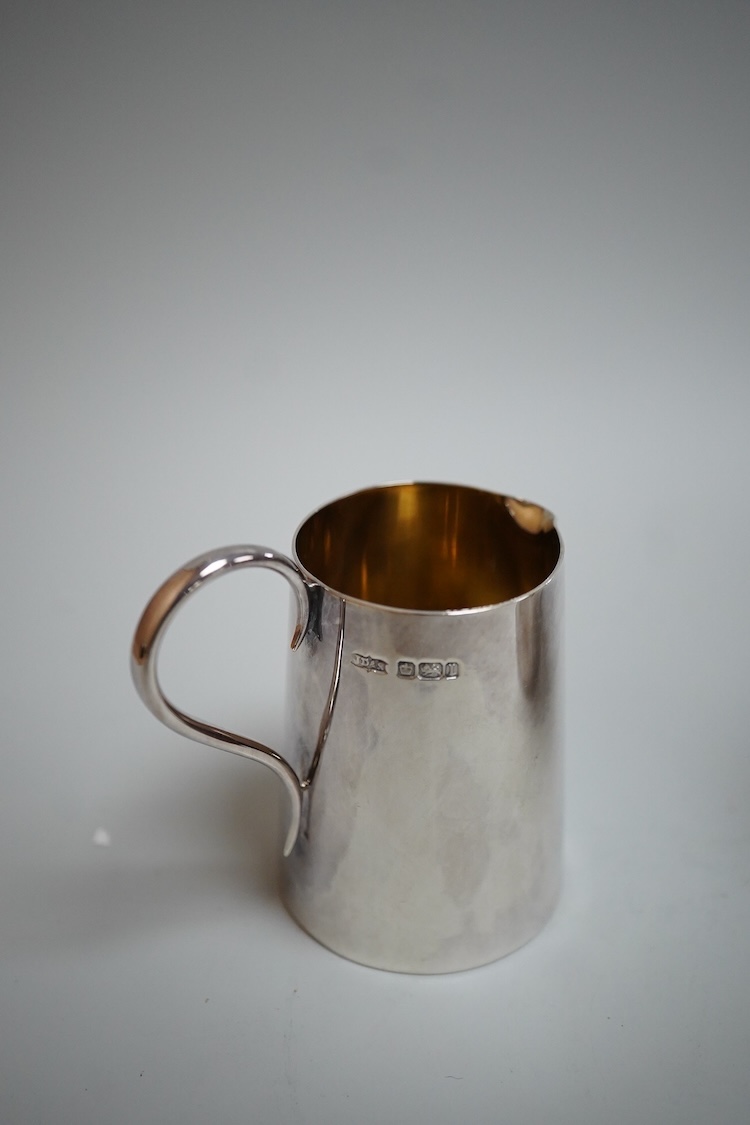 Sundry silver including two George V silver sauce boats, a silver café au lait pot, a small silver cream jug, three small silver dishes, a silver mounted glass sugar sifter and a silver mounted glass ashtray.